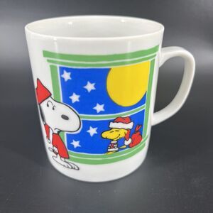 Peanuts Snoopy in Pajamas With Santa Woodstock In The Window Cup Mug
